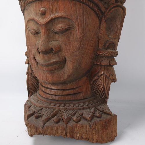 93 - A large Burmese relief carved wood mask wall carving, height 67cm