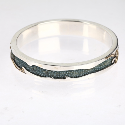 1576 - CLIVE & CLARISSA COOKE - a sterling silver 18ct gold overlaid shark skin shagreen slave bangle, make... 