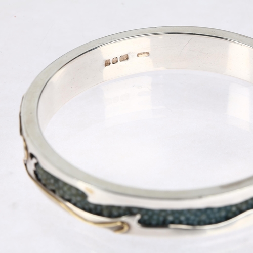 1576 - CLIVE & CLARISSA COOKE - a sterling silver 18ct gold overlaid shark skin shagreen slave bangle, make... 