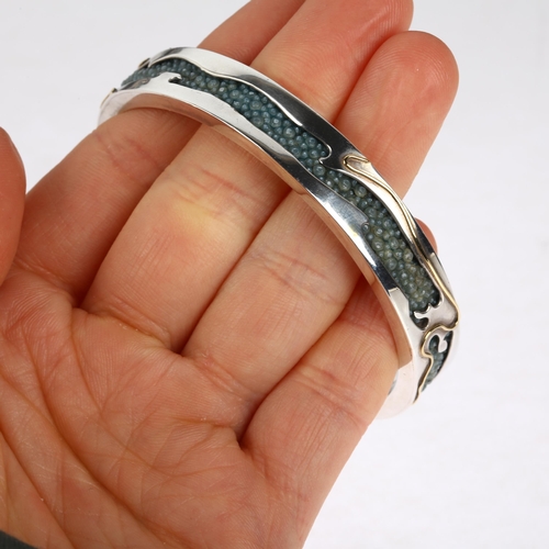 1576 - CLIVE & CLARISSA COOKE - a sterling silver 18ct gold overlaid shark skin shagreen slave bangle, make... 