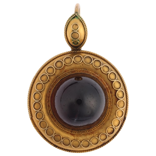 1155 - A Victorian Etruscan Revival garnet mourning locket pendant, circa 1880, centrally set with foil-bac... 