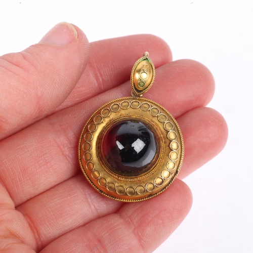 1155 - A Victorian Etruscan Revival garnet mourning locket pendant, circa 1880, centrally set with foil-bac... 