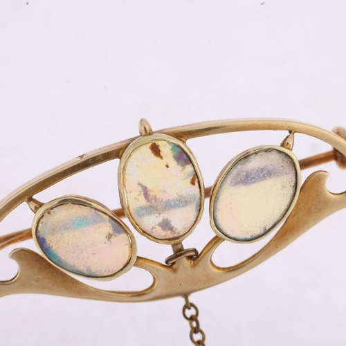 1157 - MURRLE BENNETT - an Art Nouveau 15ct gold opal openwork brooch, circa 1905, rub-over set with oval f... 