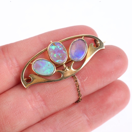 1157 - MURRLE BENNETT - an Art Nouveau 15ct gold opal openwork brooch, circa 1905, rub-over set with oval f... 