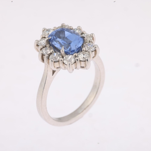 1162 - A Sri Lankan 'No Heat' sapphire and diamond oval cluster ring, centrally claw set with 2.44ct oval m... 