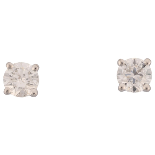 1165 - A pair of 18ct white gold 1.01ct solitaire diamond stud earrings, each claw set with individually ce... 