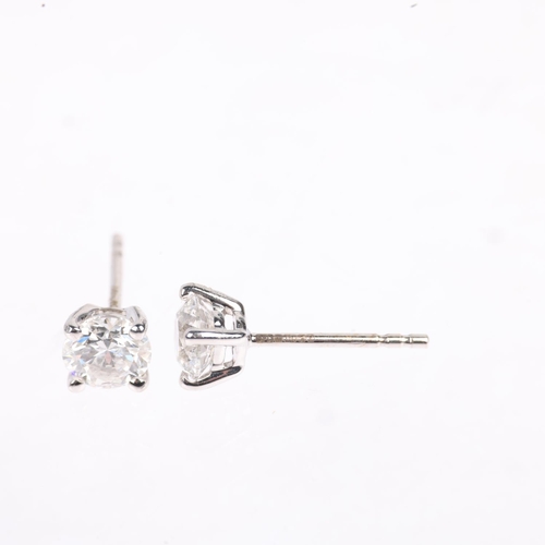 1165 - A pair of 18ct white gold 1.01ct solitaire diamond stud earrings, each claw set with individually ce... 