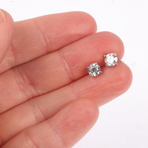 1165 - A pair of 18ct white gold 1.01ct solitaire diamond stud earrings, each claw set with individually ce... 