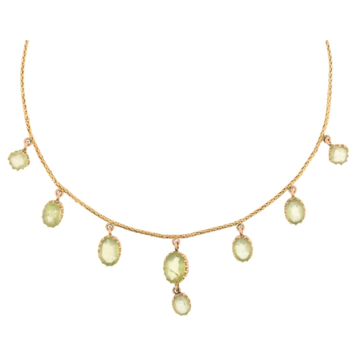 1166 - An Edwardian peridot fringe necklace, circa 1910, claw set with oval mixed-cut peridot drops, on unm... 