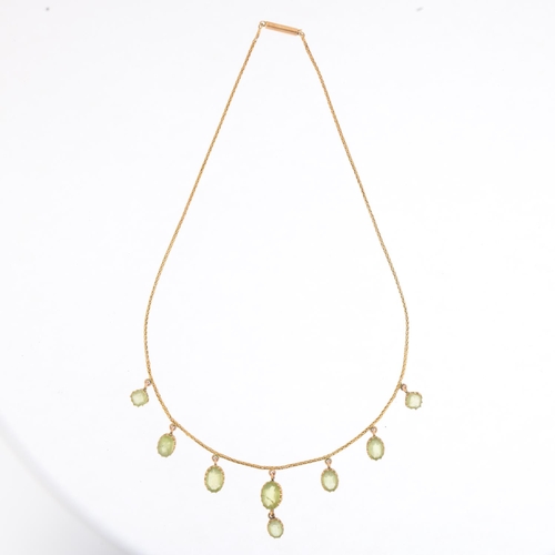 1166 - An Edwardian peridot fringe necklace, circa 1910, claw set with oval mixed-cut peridot drops, on unm... 