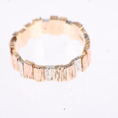 1171 - A 1980s 9ct three-colour gold abstract band ring, maker LWJ, Sheffield 1984, textured bark offset bl... 