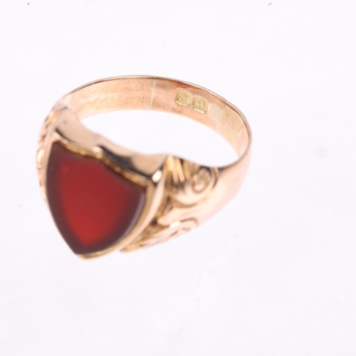 1177 - An early 20th century 9ct rose gold carnelian shield seal signet ring, Birmingham 1914, foliate engr... 