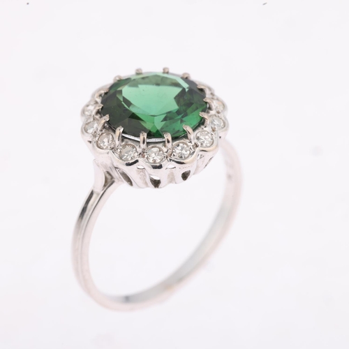 1180 - An 18ct white gold green tourmaline and diamond flowerhead cluster ring, centrally claw set with 3ct... 