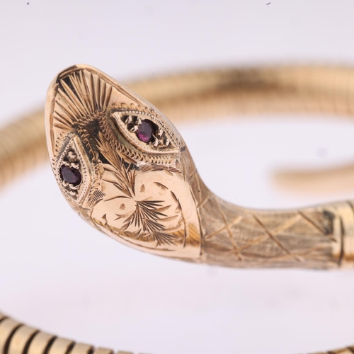 1186 - A late 20th century 9ct gold ruby figural coiled snake bangle, maker C&F, Birmingham 1971, engraved ... 