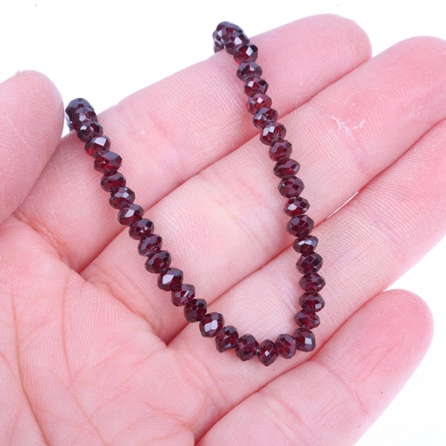 1226 - A Regency graduated faceted garnet bead necklace, maker KV, with rose-cut garnet clasp, beads measur... 