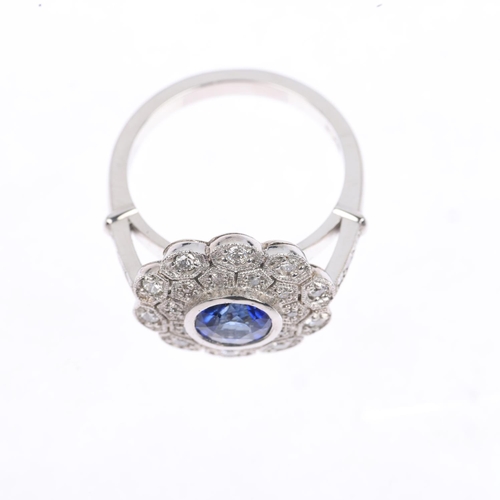 1228 - A platinum sapphire and diamond flowerhead cluster ring, maker JC, set with 1ct round-cut sapphire s... 