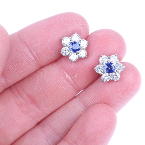 1229 - A pair of 18ct white gold sapphire and diamond flowerhead cluster earrings, claw set with round-cut ... 