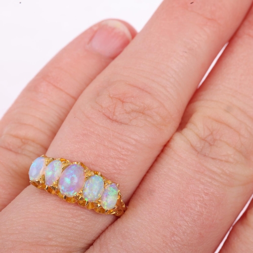 1231 - An early 20th century graduated five stone opal half hoop ring, set with oval cabochon opals, appare... 