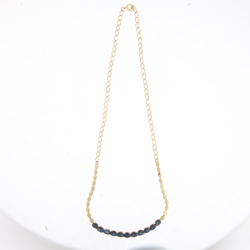 1337 - A 9ct gold sapphire line collar necklace, claw set with oval mixed-cut sapphires, 40cm, 8.1g