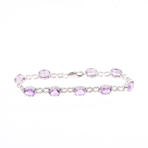 1343 - A modern 9ct white gold amethyst tennis line bracelet, 17cm, 9.9g