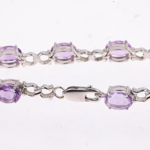 1343 - A modern 9ct white gold amethyst tennis line bracelet, 17cm, 9.9g