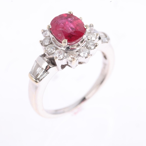 1350 - An 18ct white gold ruby and diamond flowerhead cluster ring, claw set with 1.1ct oval mixed-cut ruby... 