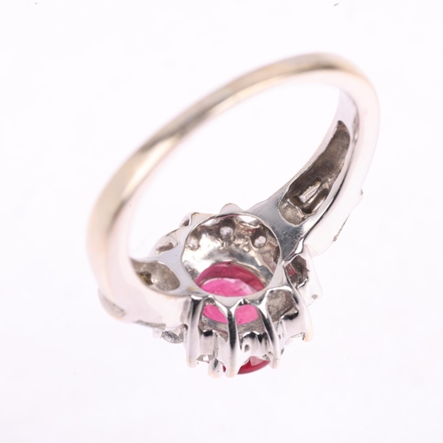 1350 - An 18ct white gold ruby and diamond flowerhead cluster ring, claw set with 1.1ct oval mixed-cut ruby... 