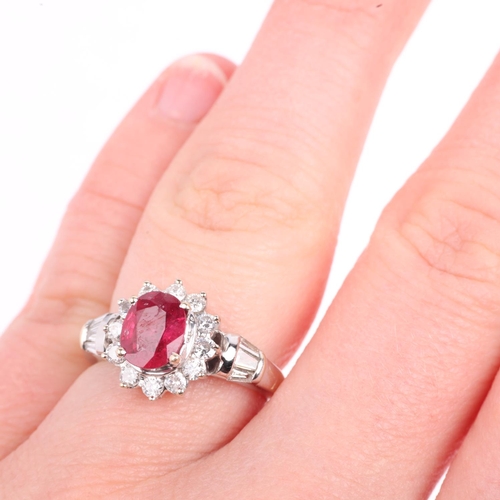 1350 - An 18ct white gold ruby and diamond flowerhead cluster ring, claw set with 1.1ct oval mixed-cut ruby... 