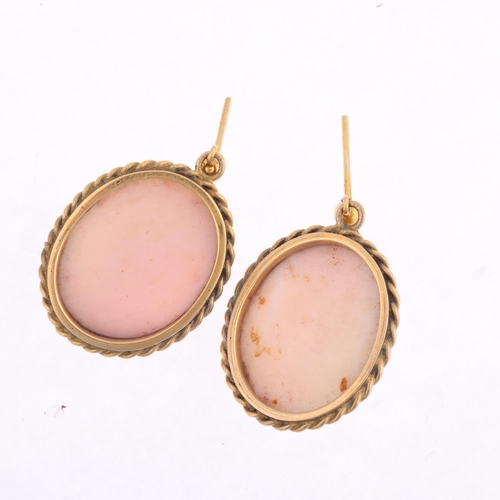 1355 - A pair of 9ct gold pink coral cameo earrings, relief carved depicting female profiles, with stud fit... 