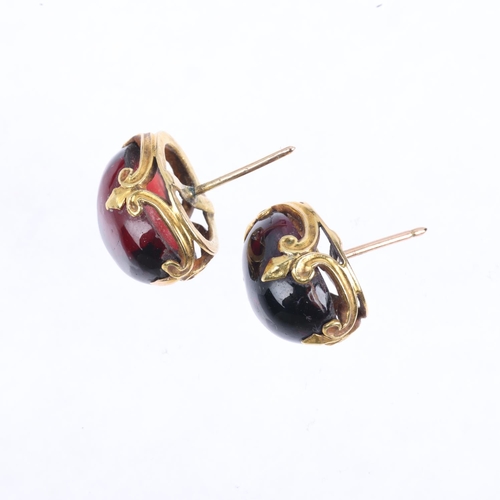 1357 - A pair of garnet earrings, with fleur-de-lis stud fittings, apparently unmarked, 15.5mm, 8g