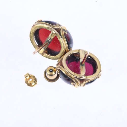 1357 - A pair of garnet earrings, with fleur-de-lis stud fittings, apparently unmarked, 15.5mm, 8g