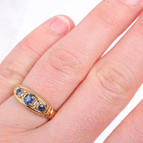 1369 - An early 20th century 18ct gold graduated five stone sapphire and diamond half hoop ring, indistinct... 