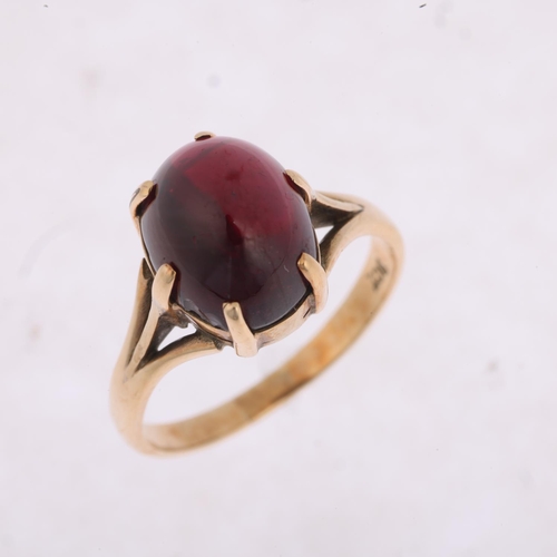 1392 - A 9ct gold garnet dress ring, claw set with oval cabochon garnet, setting height 10.8mm, size N, 3.3... 