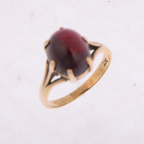 1392 - A 9ct gold garnet dress ring, claw set with oval cabochon garnet, setting height 10.8mm, size N, 3.3... 