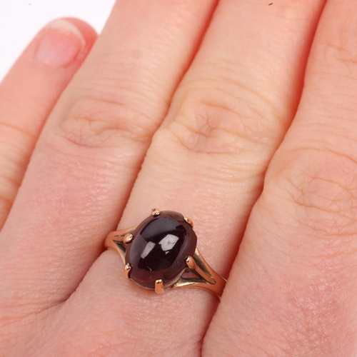 1392 - A 9ct gold garnet dress ring, claw set with oval cabochon garnet, setting height 10.8mm, size N, 3.3... 