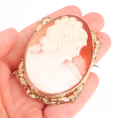 1397 - A large shell cameo brooch, relief carved depicting female profile, in unmarked 9ct gold frame, 59.8... 