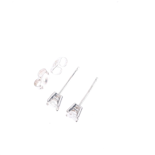 1401 - A pair of 14ct white gold 0.2ct solitaire diamond earrings, each set with 0.1ct Princess-cut diamond... 