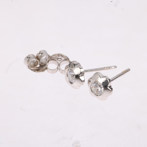 1420 - A pair of 0.2ct solitaire diamond flowerhead earrings, each set with 0.1ct modern round brilliant-cu... 