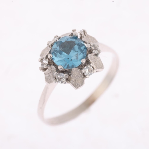 1425 - An 18ct white gold blue and white topaz flowerhead dress ring, setting height 10.7mm, size Q, 2.9g