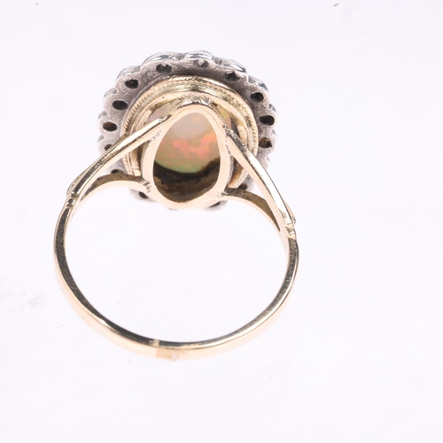 1430 - A late 20th century opal and diamond oval cluster ring, centrally set with 2.4ct oval cabochon white... 