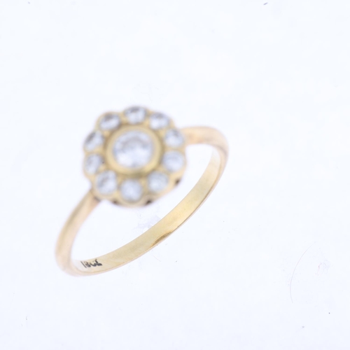 1438 - An 18ct gold diamond flowerhead cluster ring, rub-over set with modern round brilliant-cut diamonds,... 