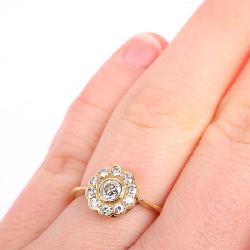 1438 - An 18ct gold diamond flowerhead cluster ring, rub-over set with modern round brilliant-cut diamonds,... 