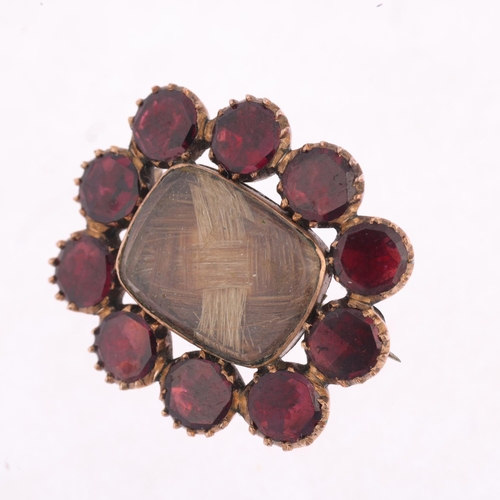 1444 - A Georgian flat-top garnet and hairwork mourning brooch, circa 1820, central woven hair panel beneat... 