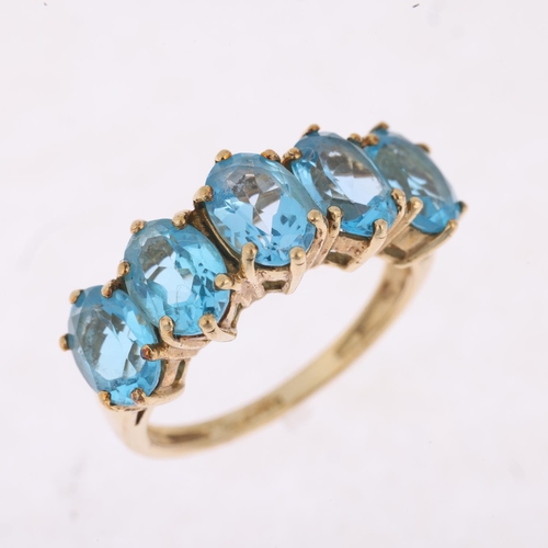 1465 - A 9ct gold five stone blue topaz half hoop ring, setting height 8mm, size M, 3.4g