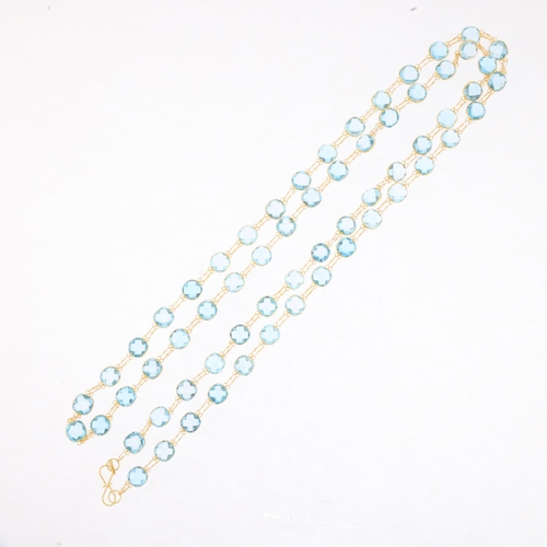 1500 - A 14ct gold blue topaz line necklace, set with double rose-cut topaz, 80cm, 16g