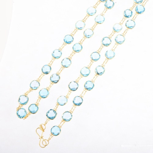 1500 - A 14ct gold blue topaz line necklace, set with double rose-cut topaz, 80cm, 16g