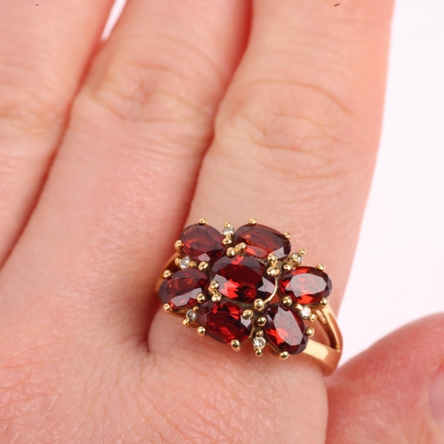 1509 - A modern 9ct gold garnet and diamond flowerhead cluster ring, setting height 13.9mm, size P, 5.5g