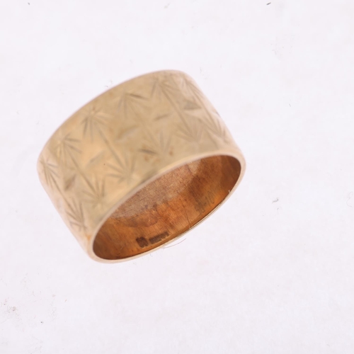 1511 - A late 20th century 9ct gold wedding band ring, maker BW, London 1973, engraved leaf decoration, ban... 