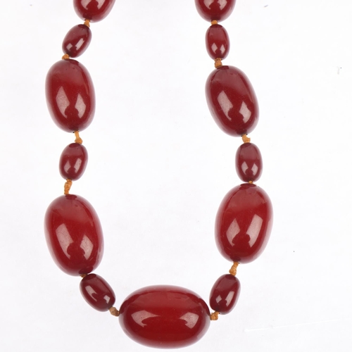 1527 - A single-strand cherry amber bead necklace, beads measure: 29.7-11.3mm, 40cm, 48.7g