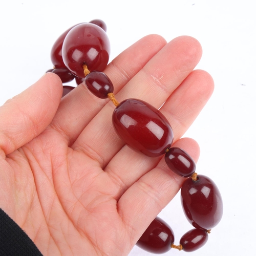 1527 - A single-strand cherry amber bead necklace, beads measure: 29.7-11.3mm, 40cm, 48.7g